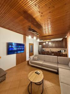 a living room with a couch and a table at Xhoni House in Elbasan