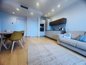 a living room with a couch and a table at Suite Luxury Seaview - Sanremo in Sanremo