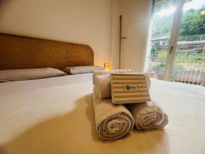 a bedroom with a bed with towels on it at Suite Luxury Seaview - Sanremo in Sanremo