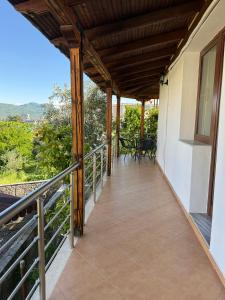 a balcony of a house with a table and chairs at Xhoni House in Elbasan