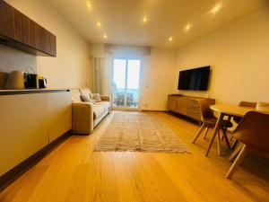 a living room with a couch and a table at Suite Luxury Seaview - Sanremo in Sanremo