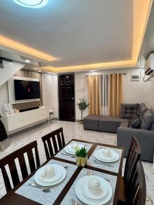 a living room with a dining table and a couch at A&F Transient House in San Felipe