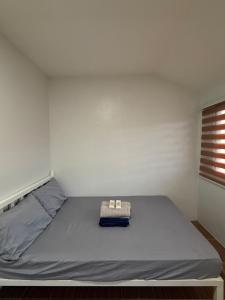 a bed in a room with a white wall at A&F Transient House in San Felipe +3 photos