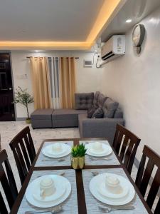 a dining table and chairs in a living room at A&F Transient House in San Felipe