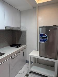 a kitchen with a refrigerator and white cabinets at A&F Transient House in San Felipe