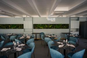 a rendering of a restaurant with tables and blue chairs at Hotel Sant'Antonio in Torraca +24 photos