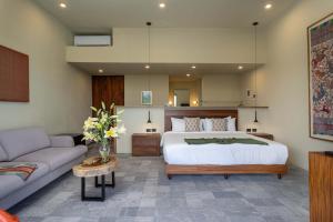 a bedroom with a large bed and a couch at Villa Lua, 2BR Countryside Bungalows for 6 Guests in La Talega +18 photos