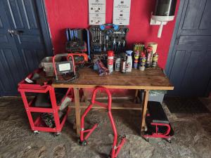 a wooden table with a bunch of tools on it at Hotel Moto-Rural "VEGALION" in Las Salas