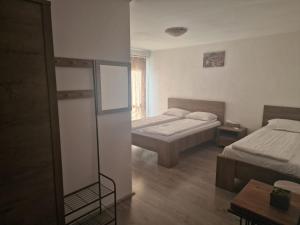 a hotel room with two beds and a mirror at Casa Bunicilor in Gîrbova