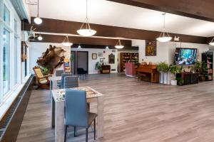 a large room with tables and chairs in a room at Nekinan Lodge in Smoky Lake