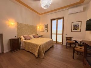 a bedroom with a bed and a table and a dining room at Alle porte di Spello in Spello