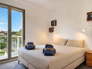 a bedroom with a bed and a large window at Exquisite Costa Blanca Escape Townhouses in El Campello