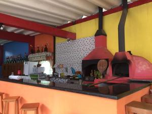 a kitchen with a red oven in a room at Suítes Recanto Renascer in Caraguatatuba