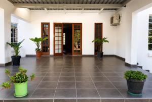 an empty room with potted plants on the floor at Gaecho Guesthouse in Thaba Nchu