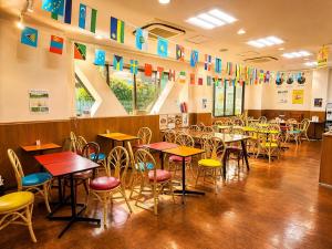 a classroom with tables and chairs and colorful flags at Sakura Hotel Hatagaya in Tokyo