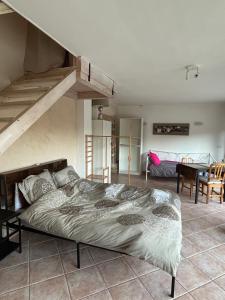 a large bed in a room with a loft at LA BASTIDETTE PROVENçALE in Jouques