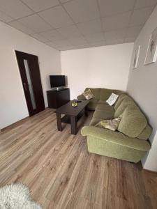 a living room with a couch and a coffee table at Cozy place in Stará Ľubovňa