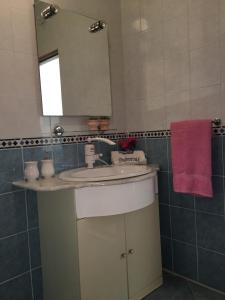 a bathroom with a sink and a mirror at Guesthouse Alliya in Dubrovnik