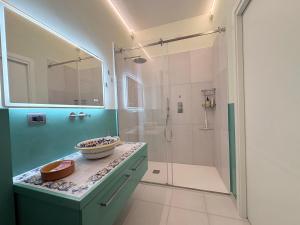 a bathroom with a walk in shower and a sink at Alle porte di Spello in Spello