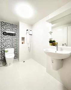 a white bathroom with a sink and a toilet at Impact poppula P1 by เจี๊ยบ in Thung Si Kan