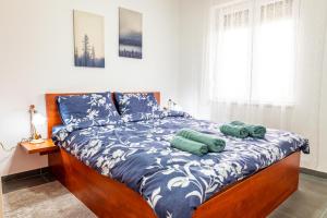 a bed with two pillows on it in a bedroom at Apartman Goga 2 in Veliko Gradište