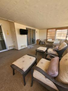 a living room with couches and chairs and a flat screen tv at CASA Allegro - Active Vacationers Paradise in Sun City West