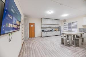 a kitchen with a table and a dining room at Arch Hostel in Almaty