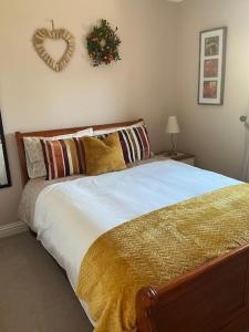a bedroom with a bed with areath on the wall at The Garden Rooms in Spittal