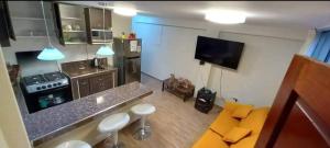 a kitchen with a stove and a counter top at Cozy Apartment in PUNO in Puno
