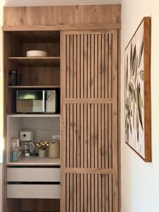 a wooden pantry door in a kitchen with a shelf at Vue de Valleé in Wellington