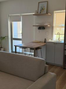 a living room with a couch and a table and a kitchen at Vue de Valleé in Wellington +5 photos
