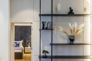 a room with black shelves with feathers on them at Cavo Mare Skopelos in Skopelos Town