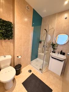 a bathroom with a shower and a toilet and a sink at Naval Guest House in Vila do Conde +70 photos