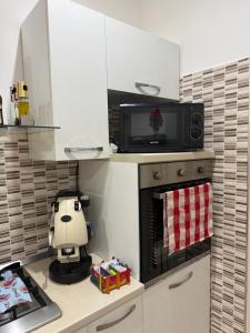 a kitchen with a toy robot on the counter at Serena Guest House in Caserta