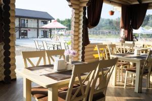 a group of tables and chairs in a restaurant at Сонячна in Solotvyno