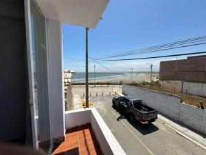 a car parked on a balcony with a view of the beach at Mamá María Surf House in Puerto Chicama +8 photos