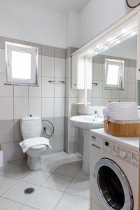 a bathroom with a washing machine and a sink at Parid Apartments in Sarandë +189 photos