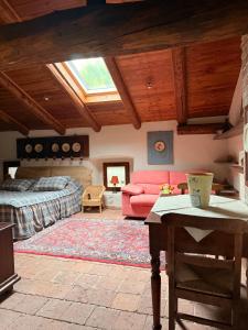 a living room with a bed and a couch at La casa Arancione in Boves