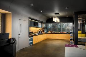 a large room with a kitchen with a large window at Aloft by Marriott Arundel Mills BWI Airport in Hanover