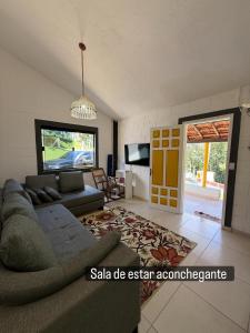 a living room with a couch and a tv at Vale Verde in Jacutinga