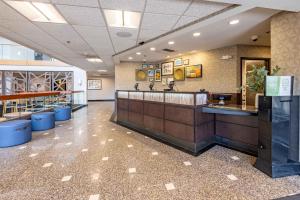 a large lobby with a counter in a restaurant at Drury Inn & Suites St. Louis Airport in Edmundson
