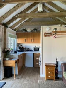 a kitchen with wooden cabinets and a table in a room at The Garden Rooms in Spittal