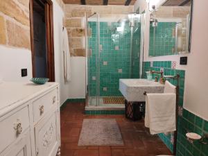 a bathroom with a sink and a shower with green tiles at Almarè Confort Rooms in Terrasini +9 photos