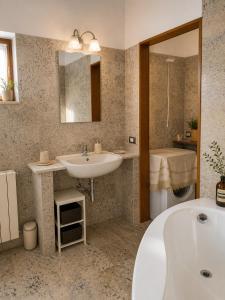 a bathroom with a tub and a sink and a shower at Il Castelletto di Gomo - Relax nella natura con SPA privata outdoor in Godiasco +43 photos