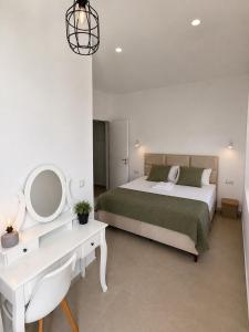 a bedroom with a bed and a desk and a mirror at Green House in Perazića Do +38 photos