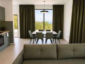 a living room with a couch and a table and chairs at Green House in Perazića Do