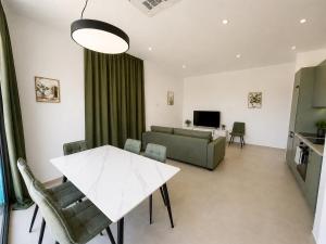a living room with a table and a couch at Green House in Perazića Do