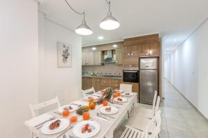 a kitchen with a table with plates of food on it at Enjoy life in our apartment. Wifi Parking in Guardamar del Segura