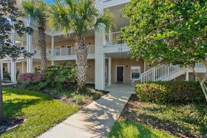 a building with palm trees in front of it at Andy's Hideaway at Bahama Bay - Sage Vacations in Kissimmee