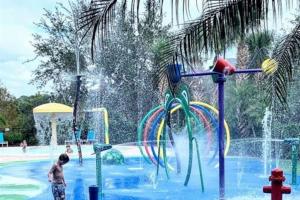 a boy is playing in a water park at Andy's Hideaway at Bahama Bay - Sage Vacations in Kissimmee